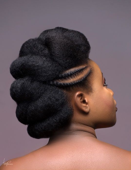 Black woman with beautifully defined natural hair, looking confident
