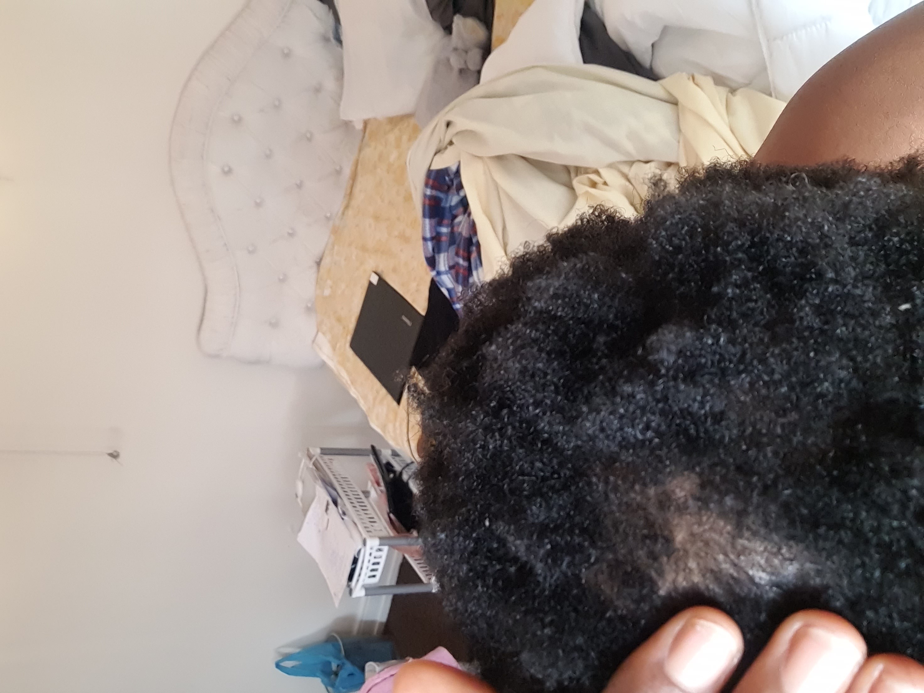 Coconut oil and natural hair care ingredients laid out beautifully