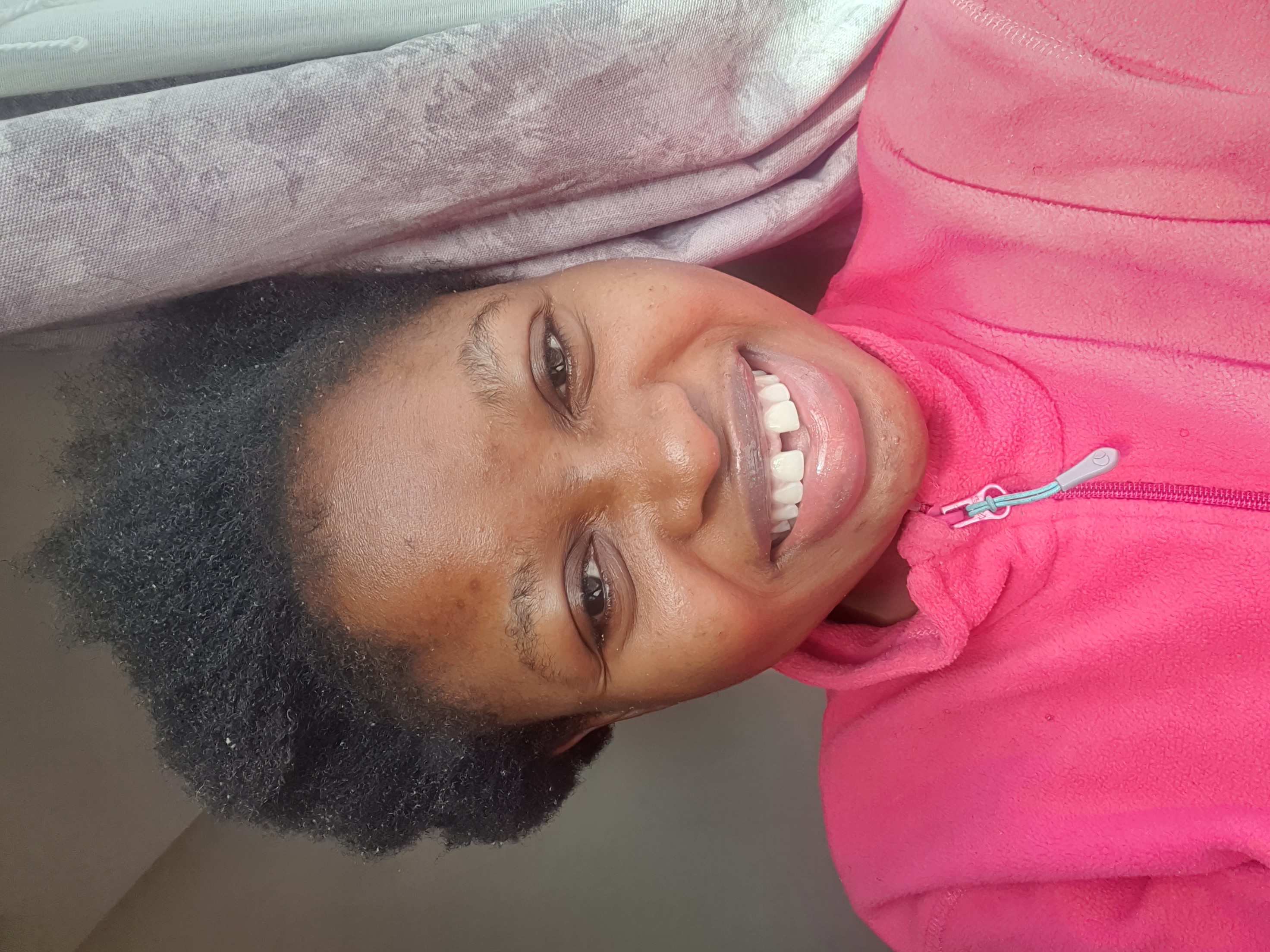 Smiling woman with a full, healthy natural afro